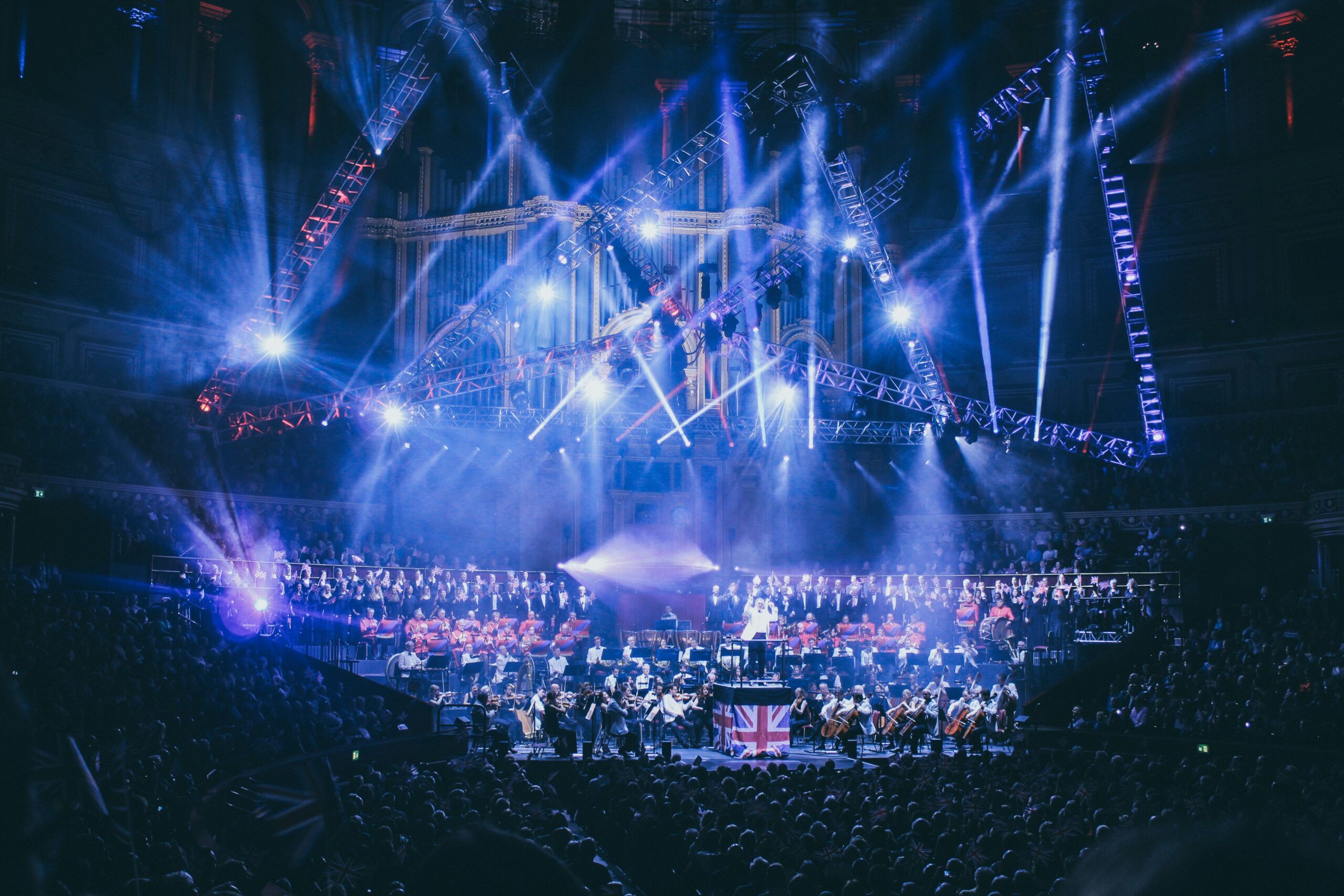 Orquesta sinfónica tocando bajo iluminación de espectáculo masivo